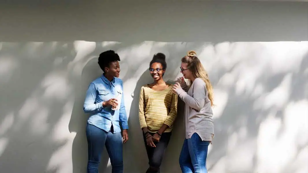 Three students enjoying a conversation